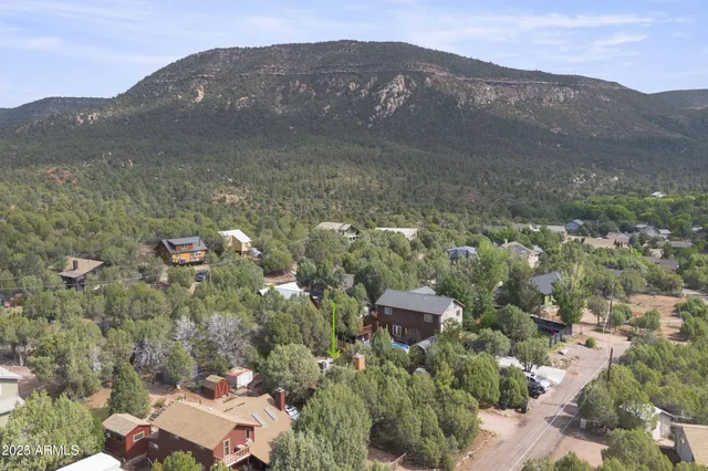 a view of a house with a mountain in the background