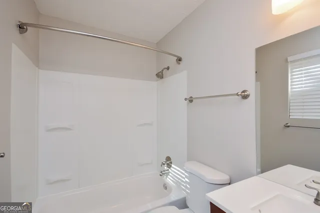 a bathroom with a bathtub and a toilet