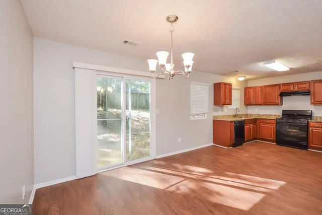 a kitchen with stainless steel appliances kitchen island a chandelier