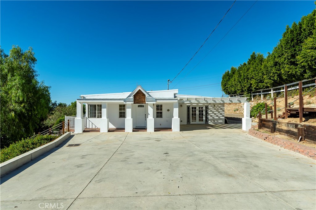10161 Foothill Boulevard Sylmar, CA 91342 - Photo 2 of 65 a front view of a house with a patio
