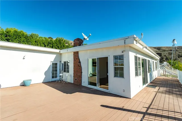 a view of a house with a wooden fence