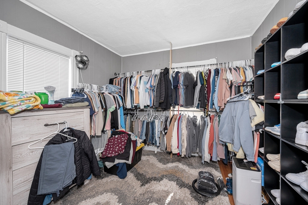 11 Sutherland Street Lowell, MA 01850 - Photo 15 of 33 a view of walk in closet with clothes and shoes