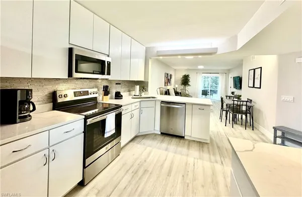 a kitchen with a sink cabinets and stainless steel appliances