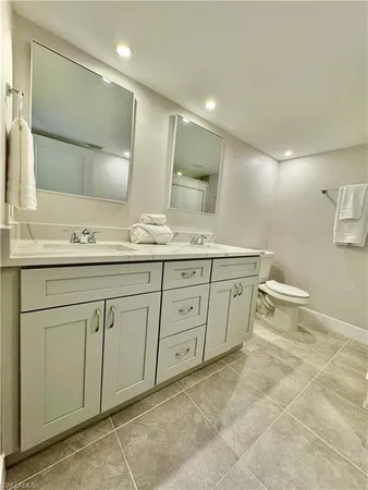 a spacious bathroom with a double vanity sink and a mirror