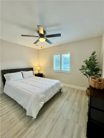 a bedroom with a bed and a potted plant