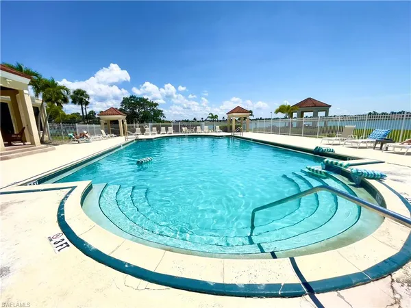 a view of a swimming pool with outdoor seating