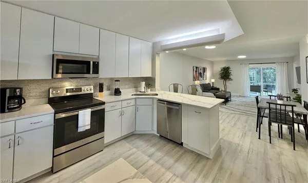 a kitchen with a sink cabinets and wooden floor