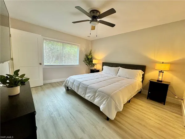 a bedroom with a bed and window