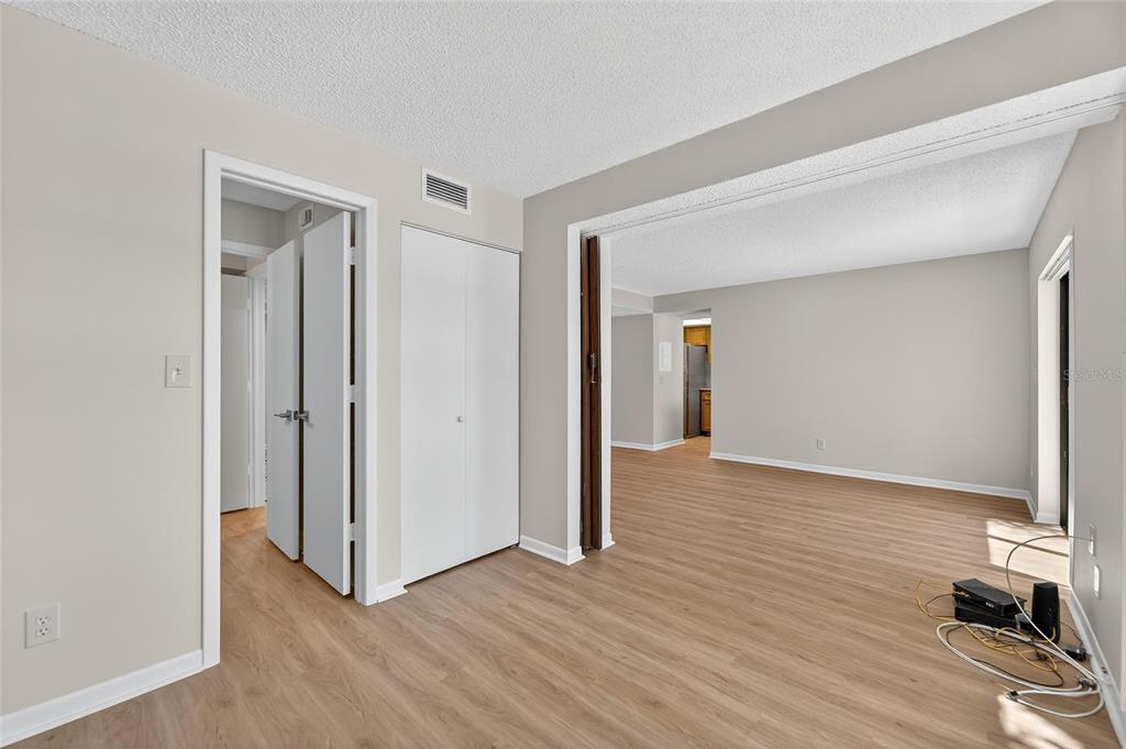 13610 South Village Drive, Unit 4209 Tampa, FL 33618 - Photo 13 of 54 a view of a livingroom with wooden floor and closet