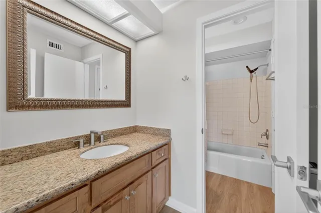 a kitchen with stainless steel appliances granite countertop a sink a stove and a refrigerator