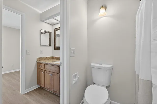 a view of a hallway with a bathroom