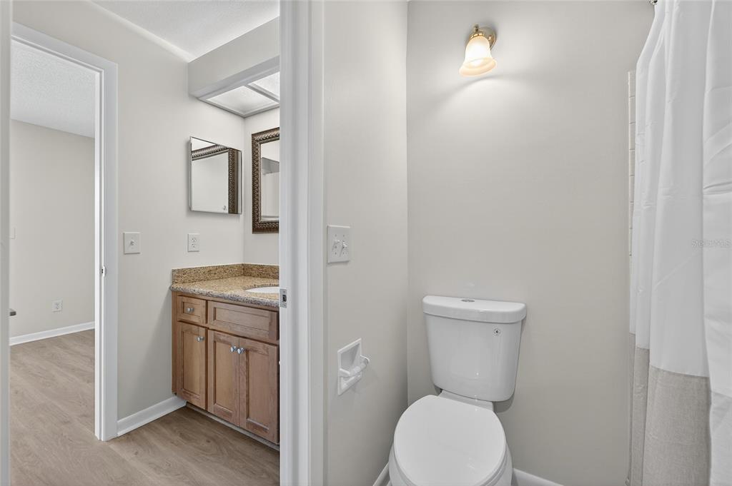 13610 South Village Drive, Unit 4209 Tampa, FL 33618 - Photo 18 of 54 a bathroom with a toilet a sink and mirror