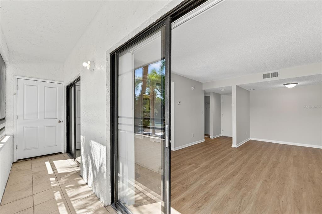 13610 South Village Drive, Unit 4209 Tampa, FL 33618 - Photo 28 of 54 a view of a hallway with wooden floor and a living room