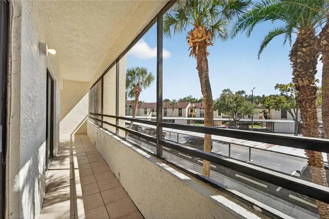 a view of a tennis room with wooden floor