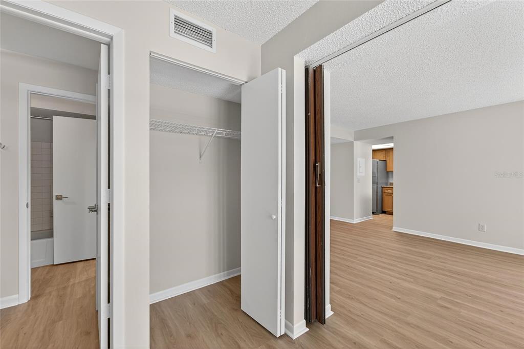 13610 South Village Drive, Unit 4209 Tampa, FL 33618 - Photo 37 of 54 a view of an empty room with wooden floor & closet