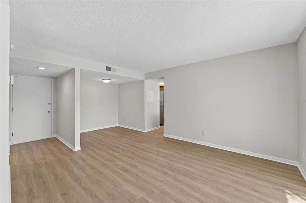 13610 South Village Drive, Unit 4209 Tampa, FL 33618 - Photo 5 of 54 a view of an empty room with wooden floor