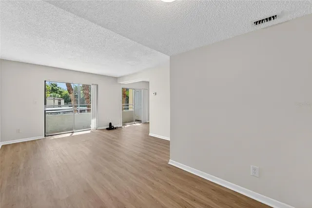 a view of a livingroom with wooden floor and closet