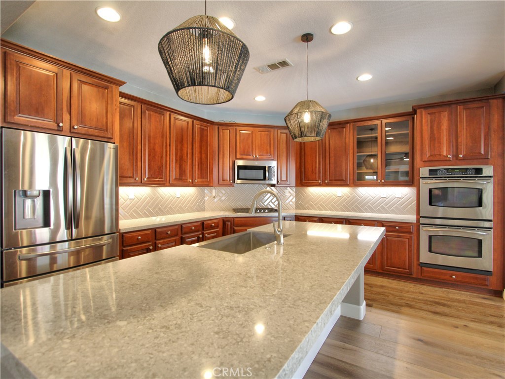1442 Midnight Sun Drive Beaumont, CA 92223 - Photo 16 of 46 an open kitchen with wooden floor and large window