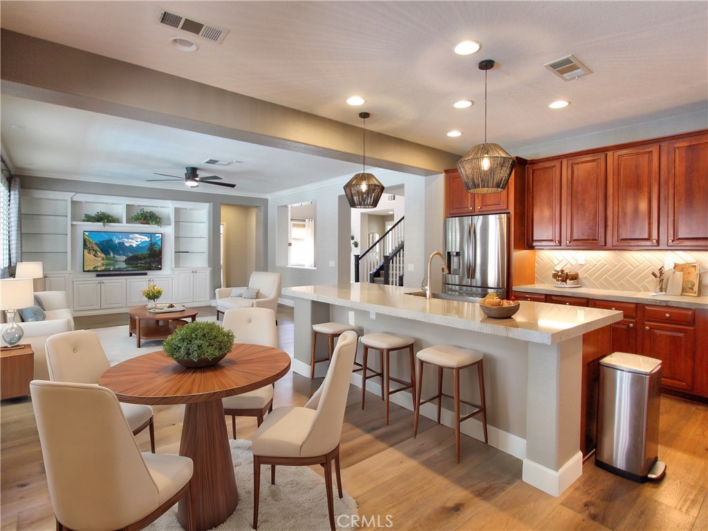 1442 Midnight Sun Drive Beaumont, CA 92223 - Photo 19 of 46 a kitchen with stainless steel appliances granite countertop a sink a stove and a refrigerator