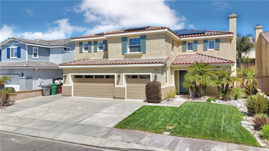 1442 Midnight Sun Drive Beaumont, CA 92223 - Photo 3 of 46 a front view of a house with a yard and garage
