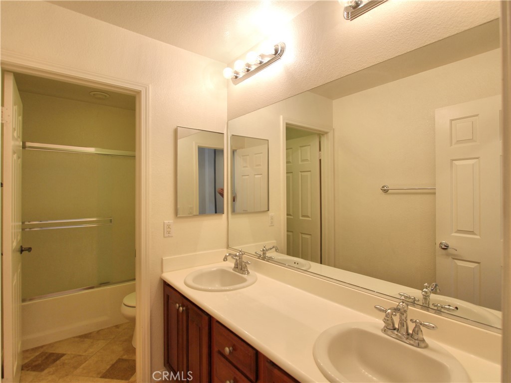 1442 Midnight Sun Drive Beaumont, CA 92223 - Photo 31 of 46 a bathroom with a sink and a mirror