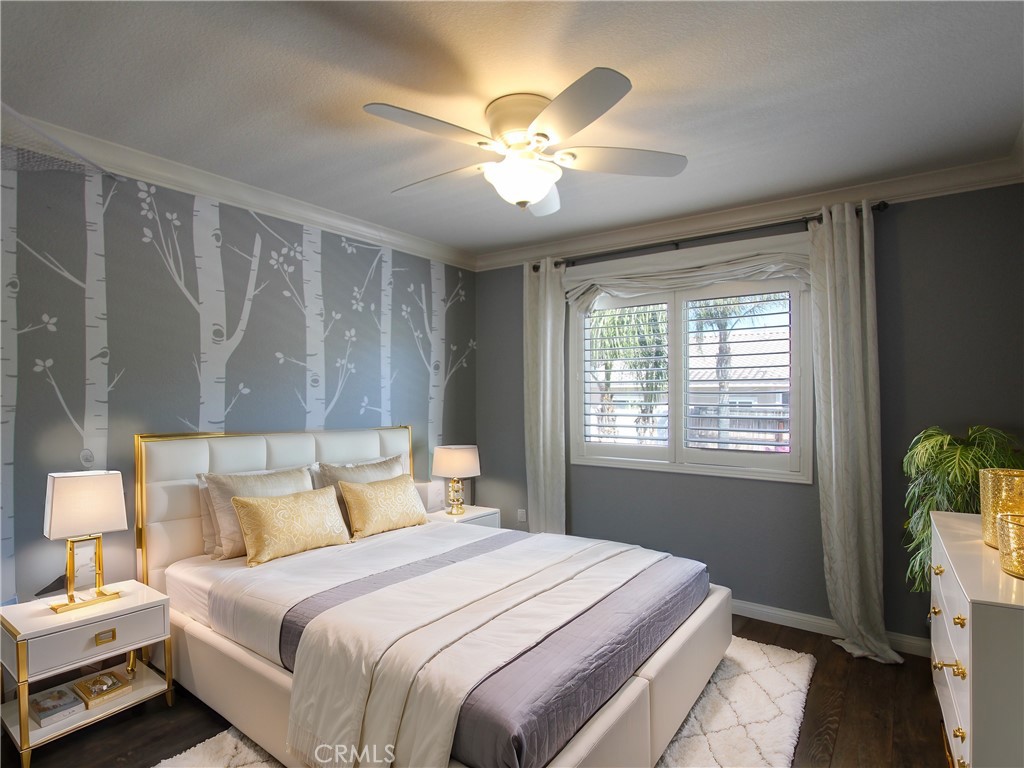 1442 Midnight Sun Drive Beaumont, CA 92223 - Photo 33 of 46 a bedroom with a bed and a chandelier