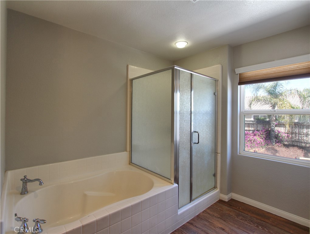 1442 Midnight Sun Drive Beaumont, CA 92223 - Photo 37 of 46 a bathroom with a bathtub and a shower