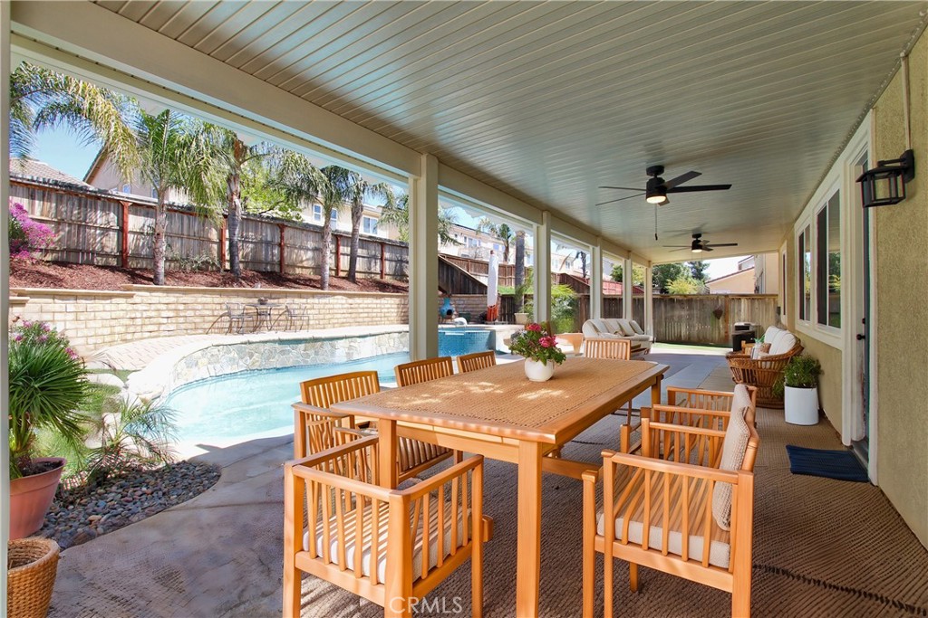 1442 Midnight Sun Drive Beaumont, CA 92223 - Photo 38 of 46 a view of a patio with table and chairs and potted plants