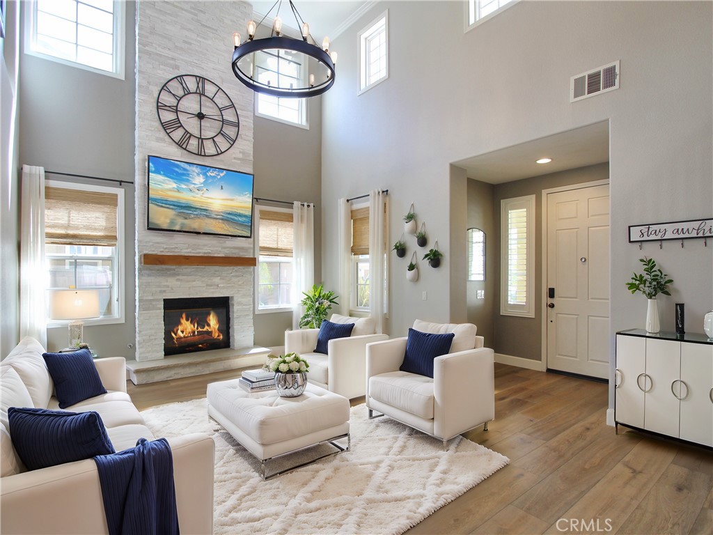 1442 Midnight Sun Drive Beaumont, CA 92223 - Photo 7 of 46 a living room with furniture a fireplace and a large mirror