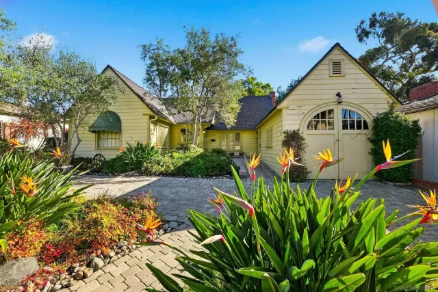 a front view of a house with a garden