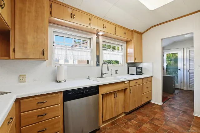 a kitchen with stainless steel appliances granite countertop a sink and a cabinets