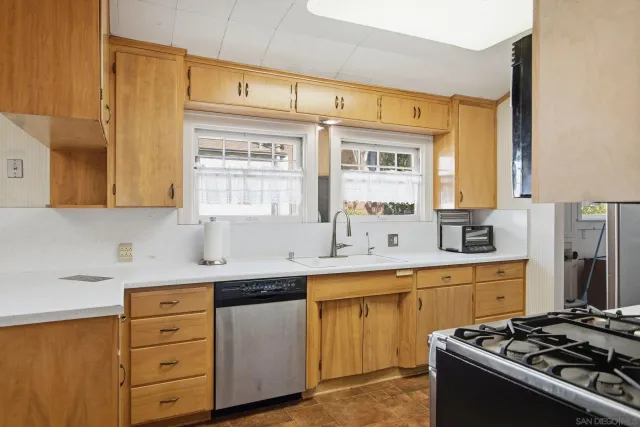 a kitchen with a sink stove and cabinets