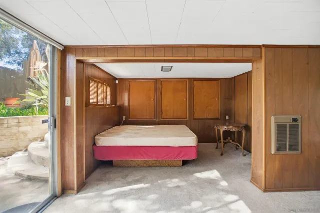 a bedroom with a bed and large window