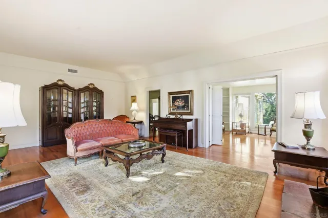 a living room with furniture a rug and a table