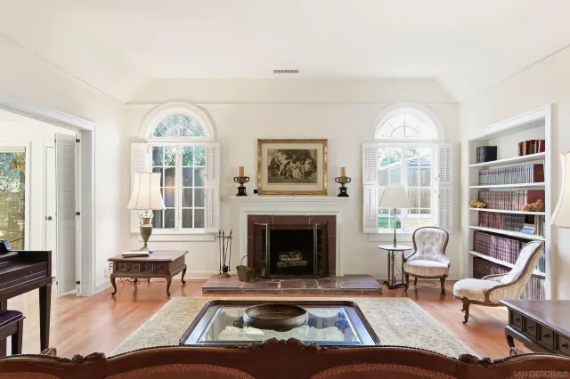 a living room with furniture fireplace and a large window