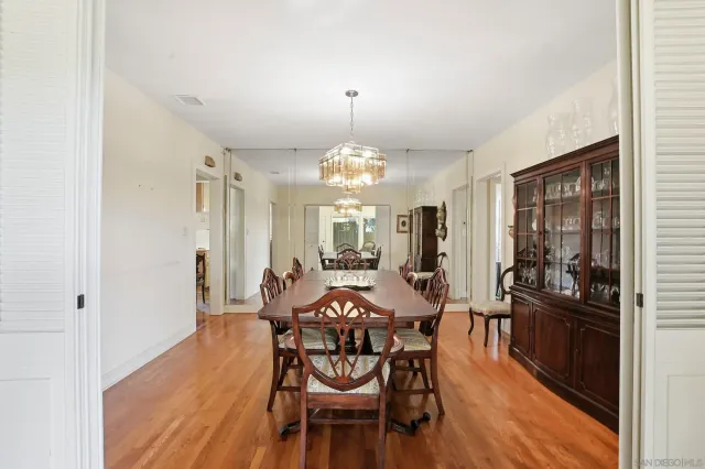 a view of a dining room with furniture and chandelier