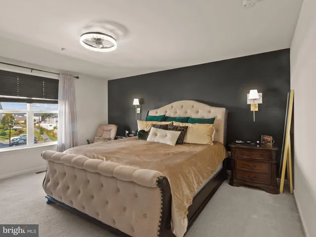 a bedroom with a bed and a tv on dresser