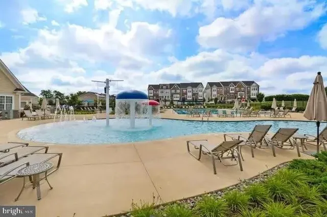 a view of a swimming pool with a table and chairs
