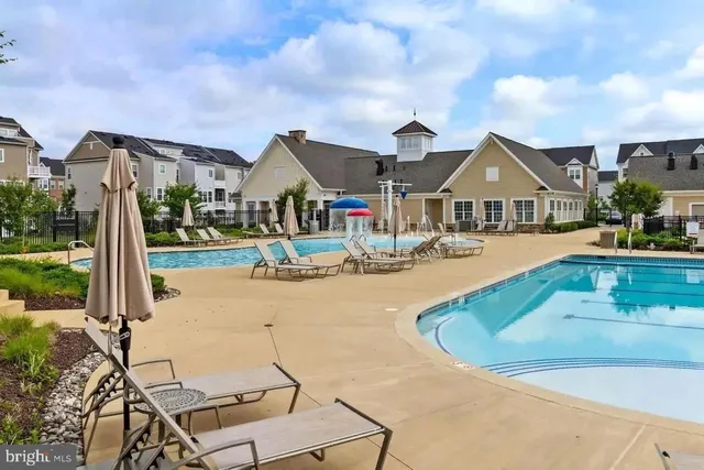a swimming pool with outdoor seating yard and barbeque oven