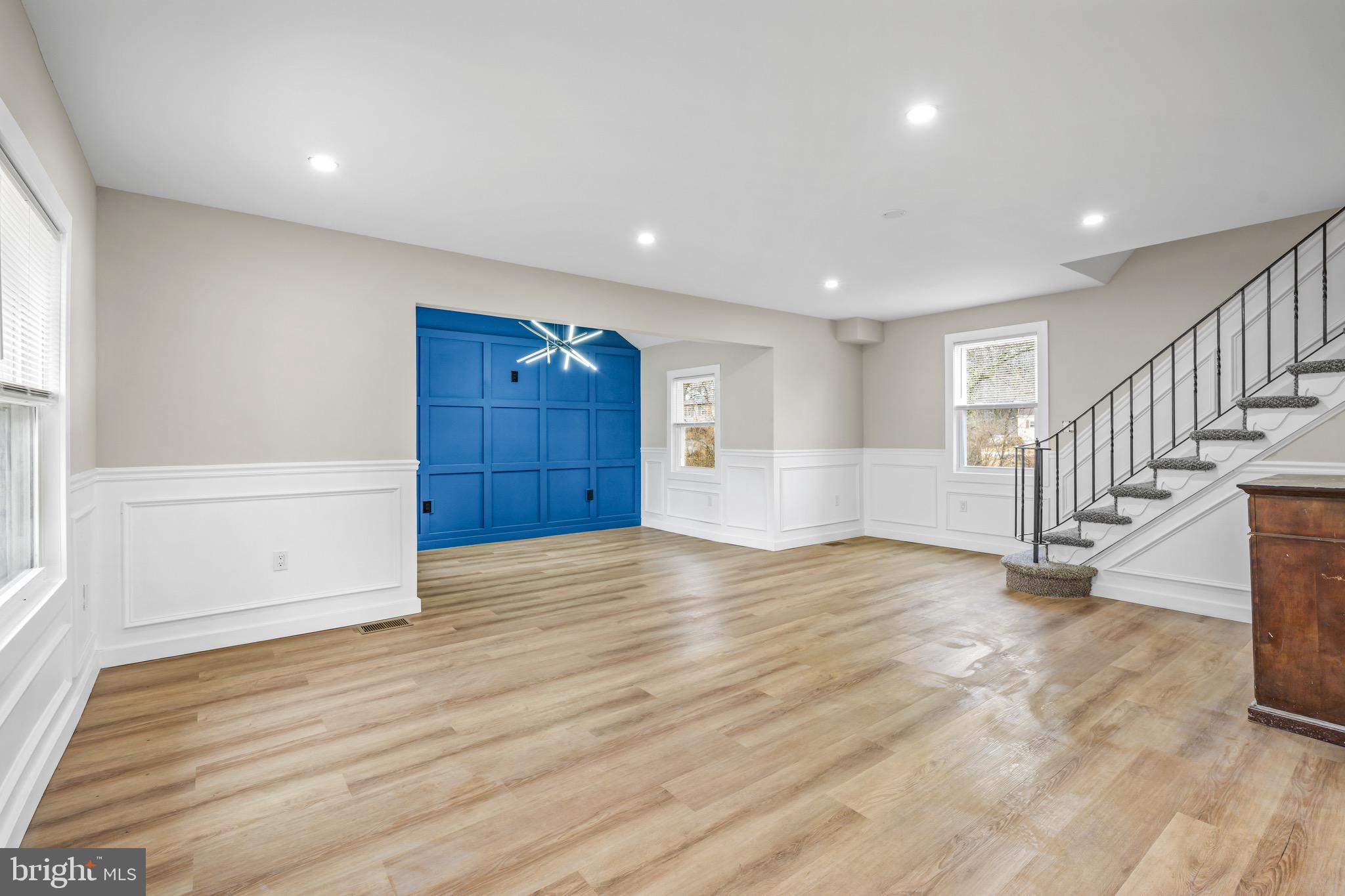 613 Hawks Bridge Road Carneys Point, NJ 08069 - Photo 16 of 38 a view of an empty room with wooden floor and stairs