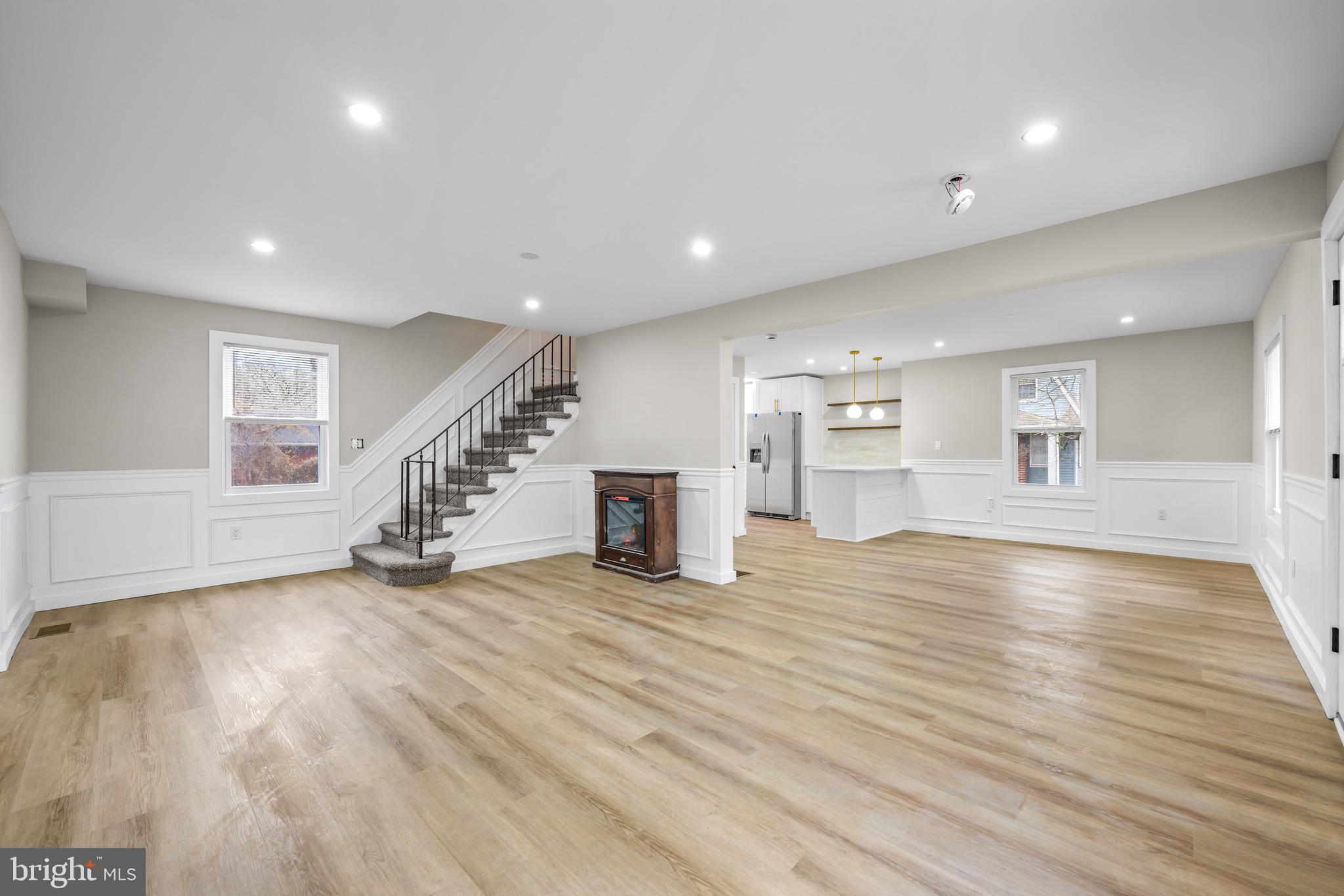 613 Hawks Bridge Road Carneys Point, NJ 08069 - Photo 3 of 38 an empty room with wooden floor and fireplace