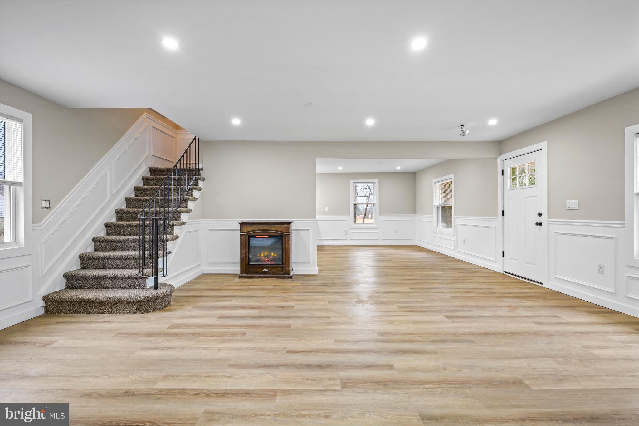 613 Hawks Bridge Road Carneys Point, NJ 08069 - Photo 5 of 38 a view of an empty room with wooden floor and a window