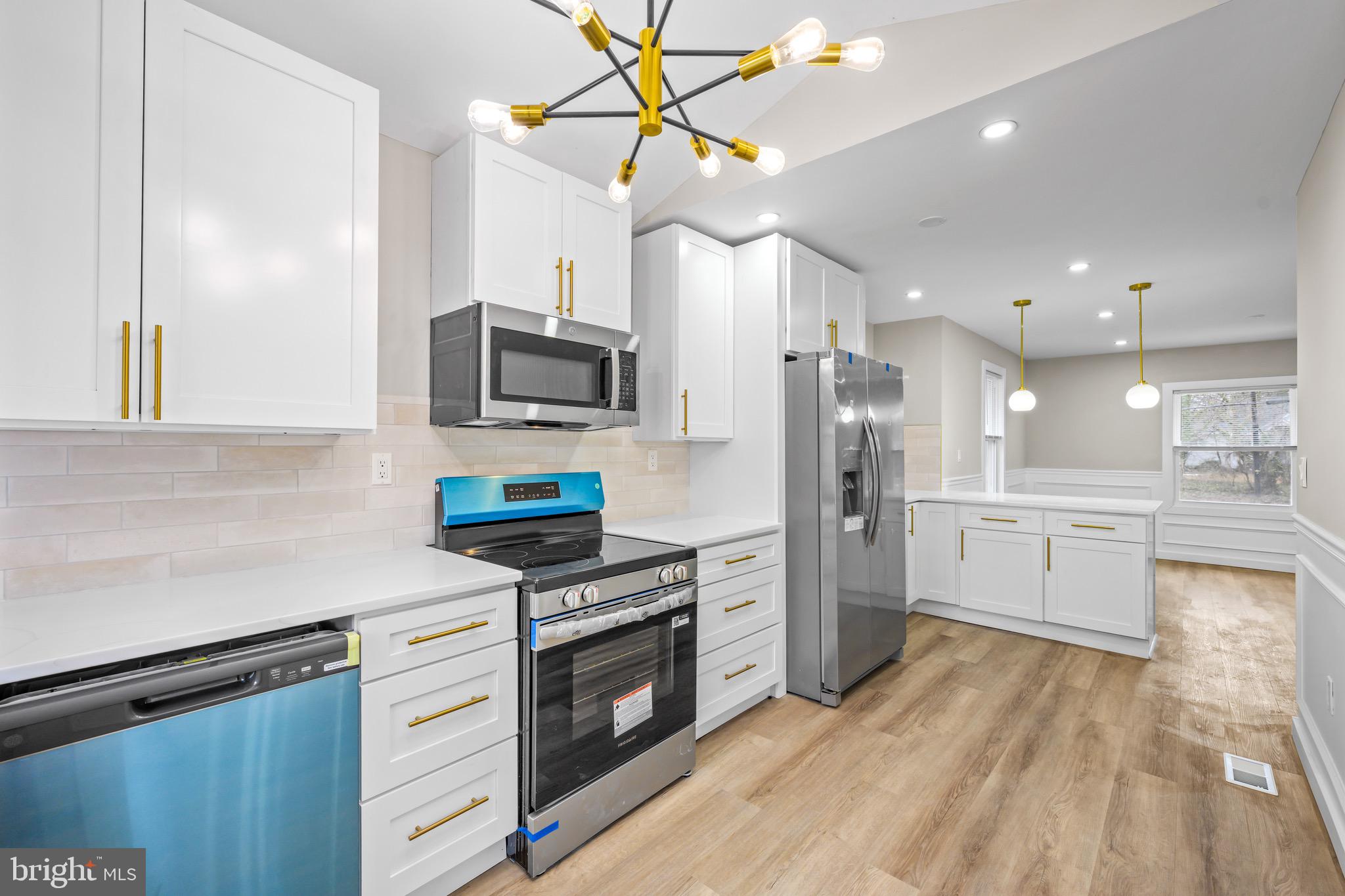 613 Hawks Bridge Road Carneys Point, NJ 08069 - Photo 6 of 38 a kitchen with a sink stainless steel appliances and cabinets