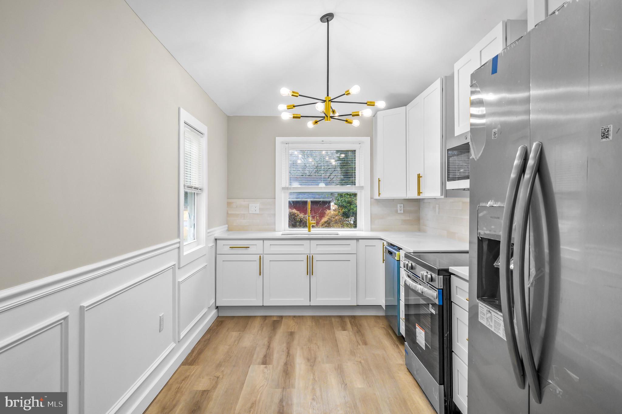 613 Hawks Bridge Road Carneys Point, NJ 08069 - Photo 8 of 38 a kitchen with a refrigerator and a sink