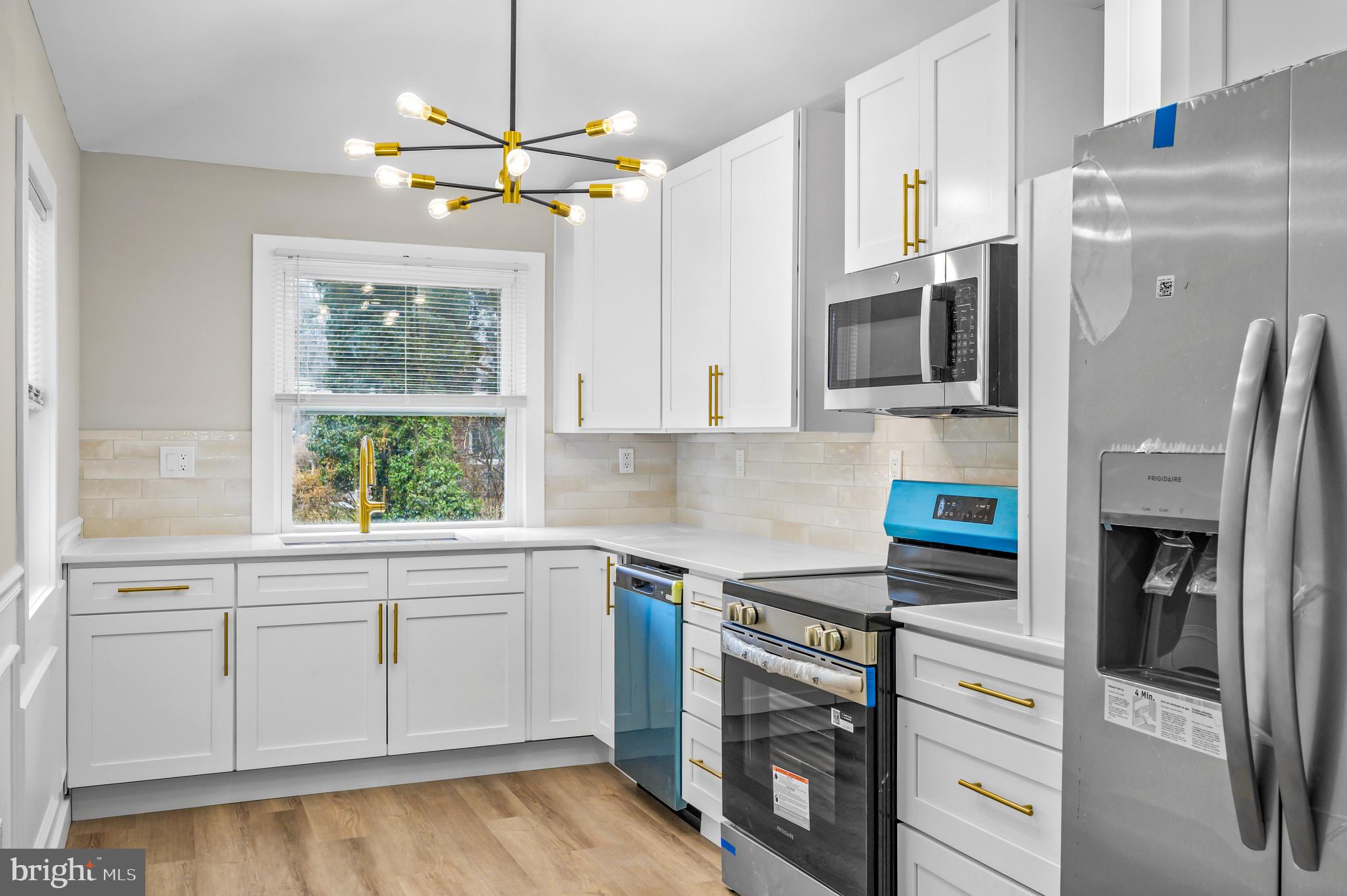 613 Hawks Bridge Road Carneys Point, NJ 08069 - Photo 9 of 38 a kitchen with stainless steel appliances a stove a refrigerator and cabinets