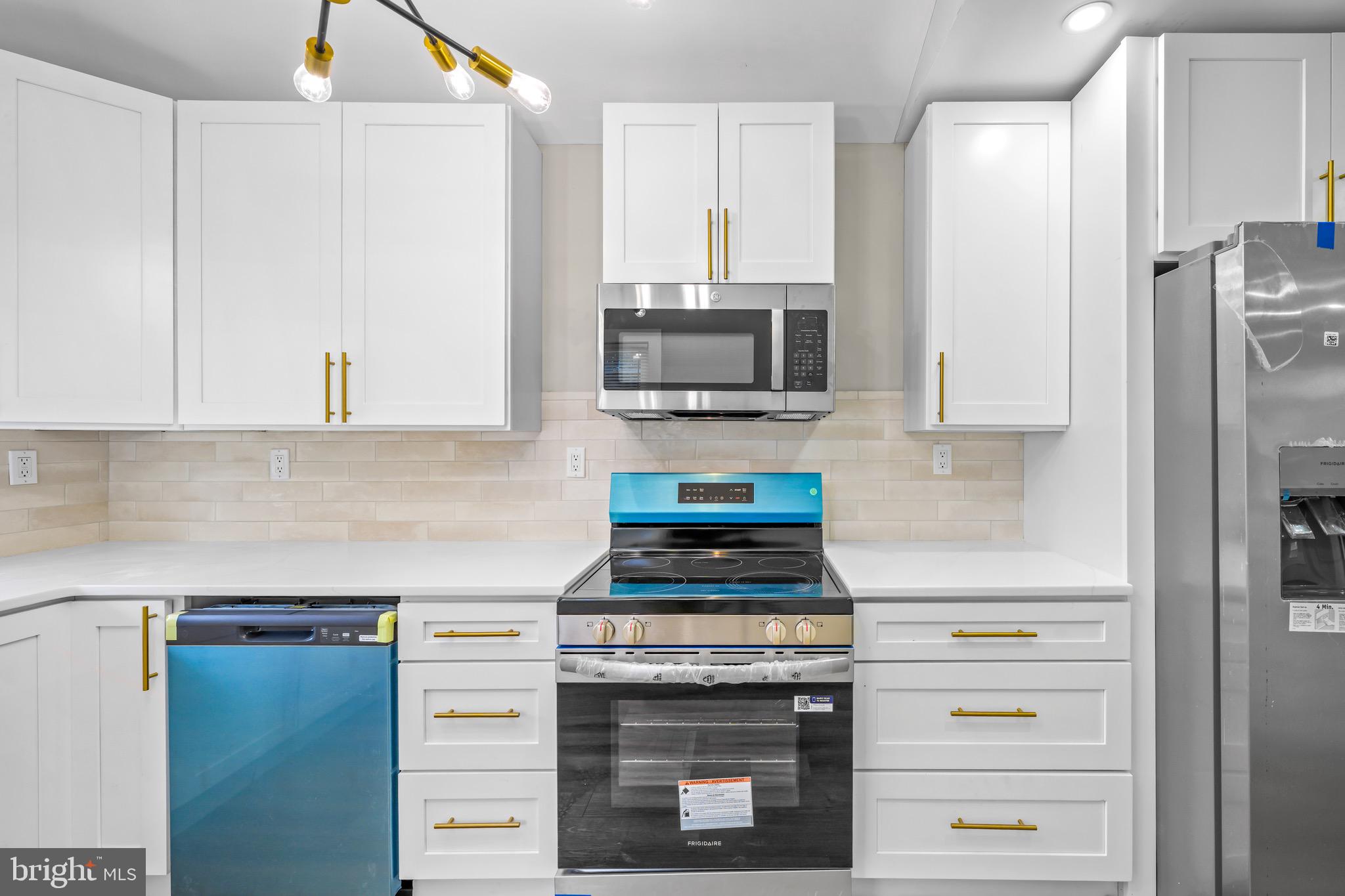 613 Hawks Bridge Road Carneys Point, NJ 08069 - Photo 10 of 38 a kitchen with stainless steel appliances white cabinets and a stove