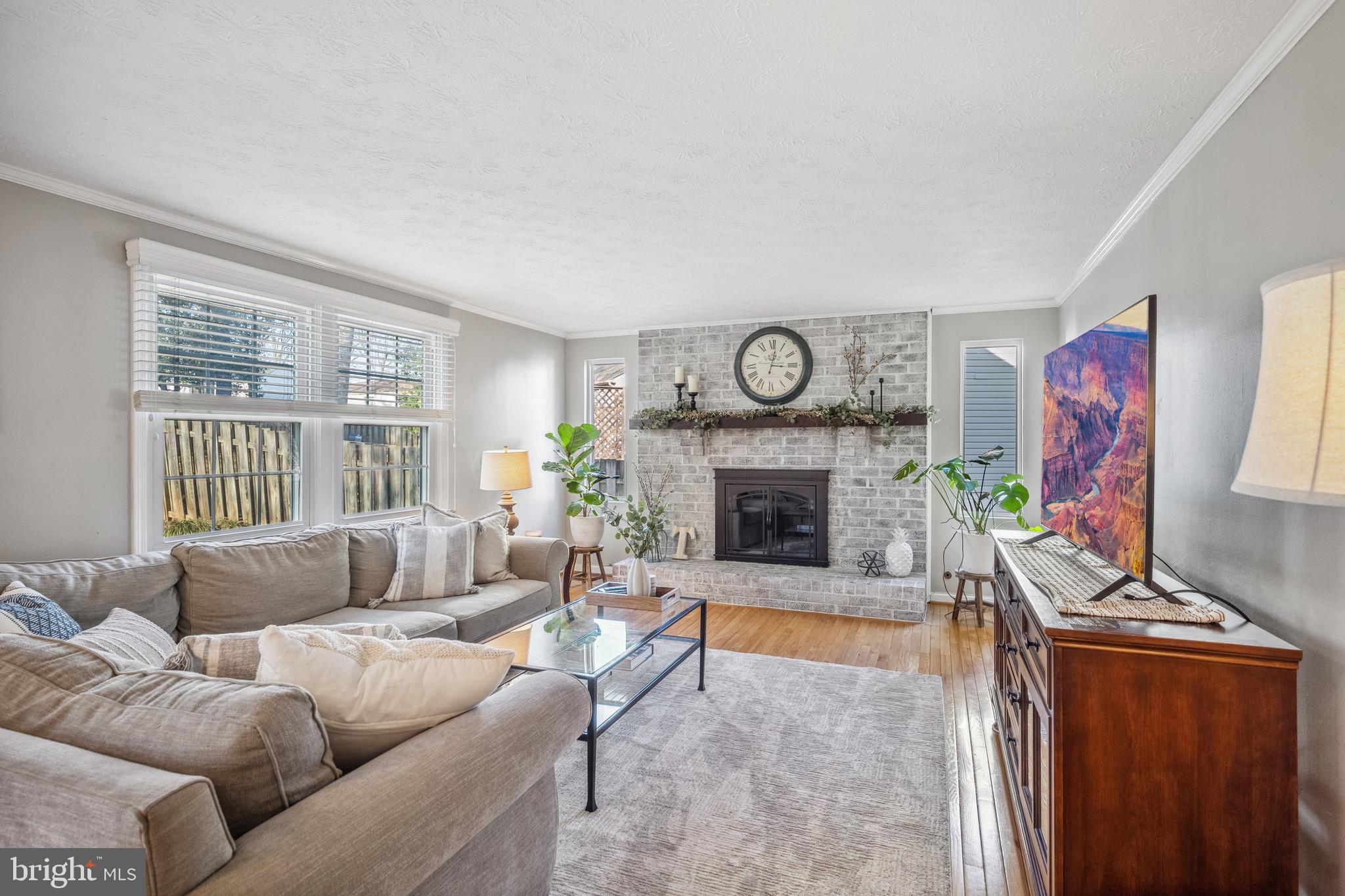 10655 John Ayres Drive Fairfax, VA 22032 - Photo 14 of 57 a living room with furniture a clock and a fireplace