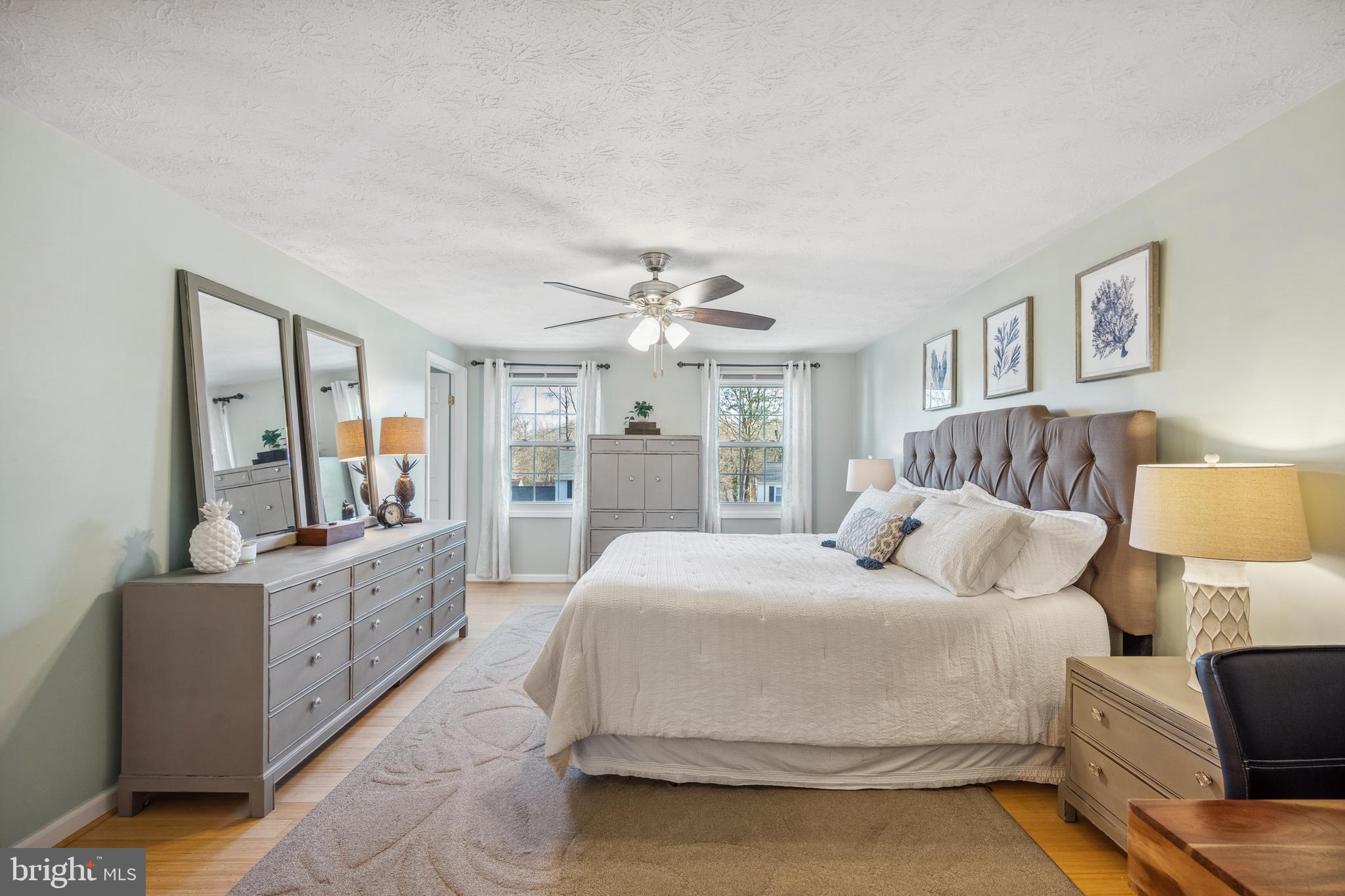 10655 John Ayres Drive Fairfax, VA 22032 - Photo 18 of 57 a bedroom with a large bed and a chandelier