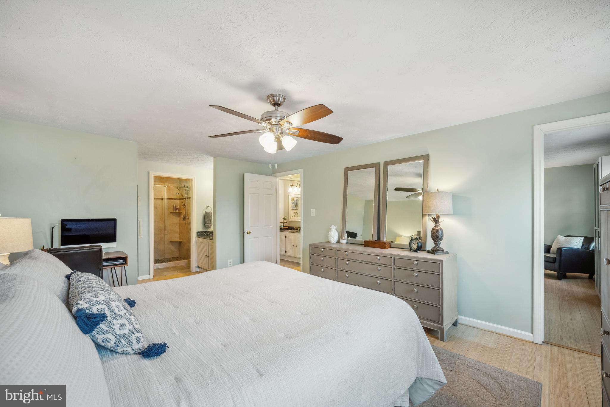 10655 John Ayres Drive Fairfax, VA 22032 - Photo 19 of 57 a bedroom with a large bed and a chandelier