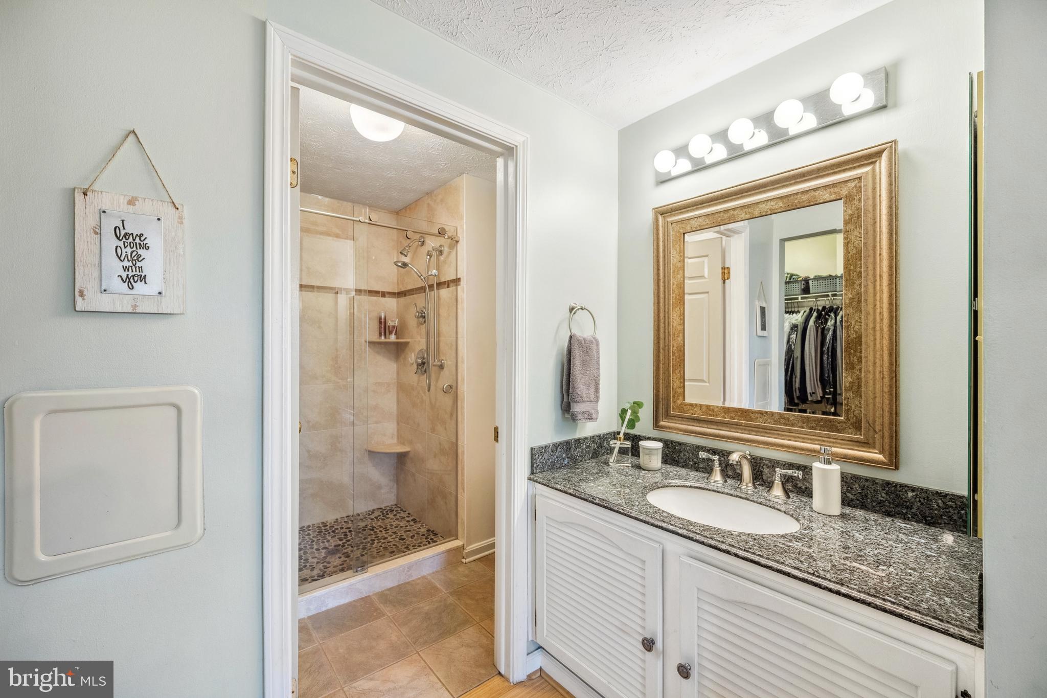 10655 John Ayres Drive Fairfax, VA 22032 - Photo 21 of 57 a bathroom with a granite countertop sink mirror and shower